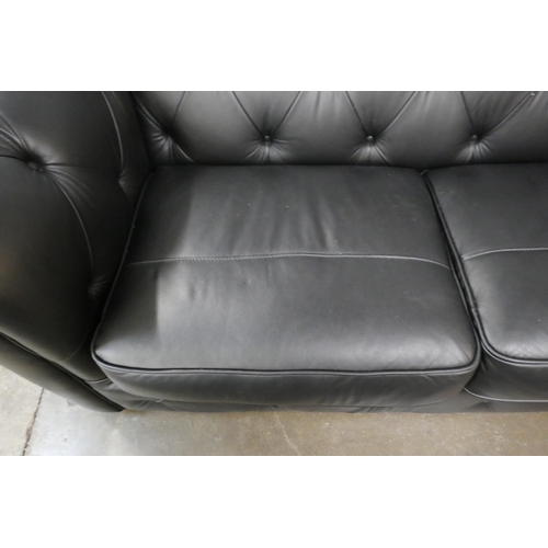 3067 - A black leather Chesterfield three seater sofa bed