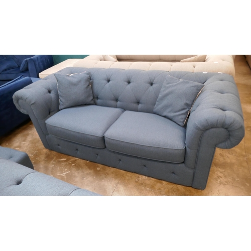 3100 - A blue upholstered Chesterfield three seater sofa-bed