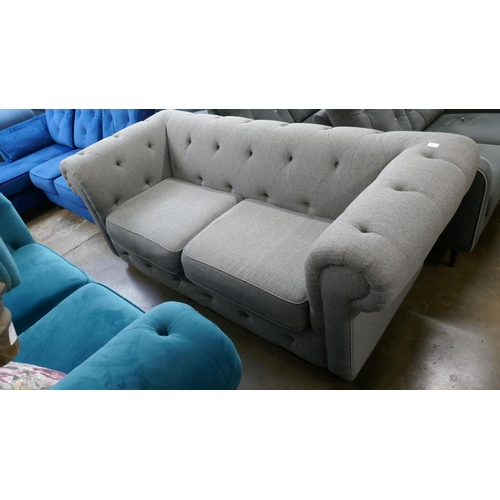 3109 - A grey upholstered Chesterfield three seater sofa