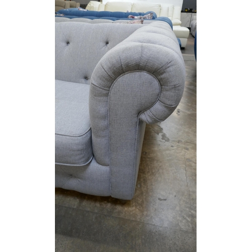 3152 - A grey upholstered Chesterfield two seater sofa and footstool