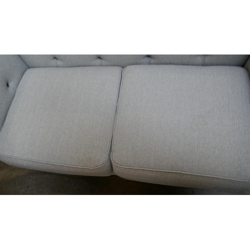 3152 - A grey upholstered Chesterfield two seater sofa and footstool