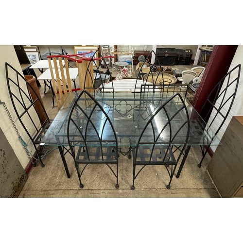 249 - A Gothic style wrought iron and glass topped garden table and six chairs