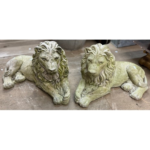 265 - A pair of concrete garden figures of recumbent lions