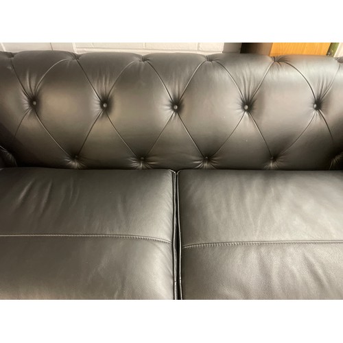 3068 - A black leather Chesterfield three seater sofa