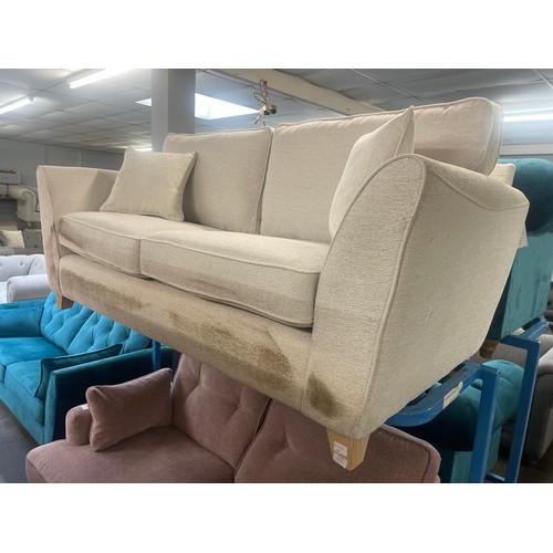 3119 - An ivory weave three seater sofa - transit damaged