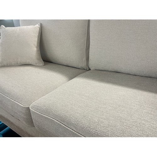 3119 - An ivory weave three seater sofa - transit damaged