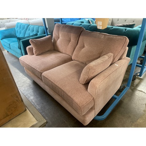 3120 - A pink upholstered two seater sofa