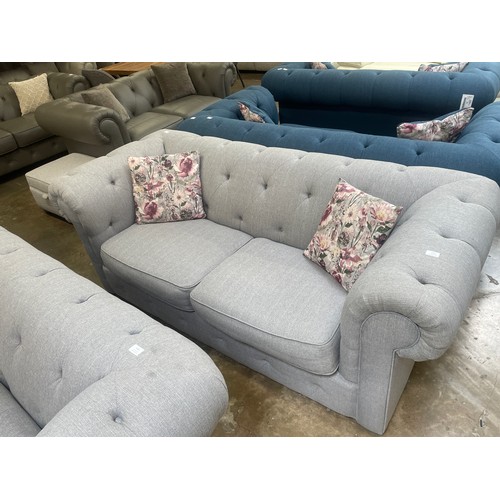 3151 - A grey upholstered Chesterfield three seater sofa bed