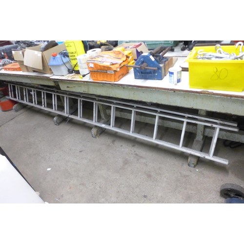 5006A - A set of double 14 rung extending metal ladders