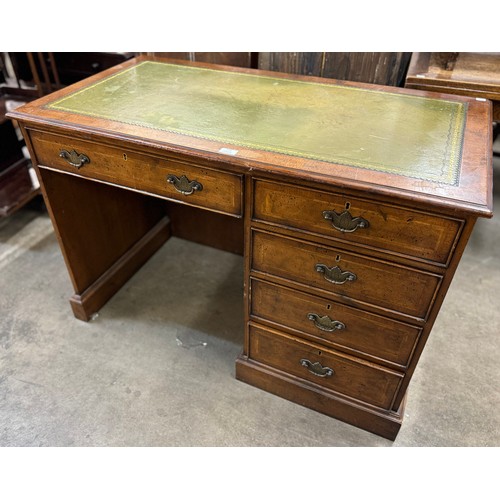 179 - A George III style inlaid mahogany and green leather topped desk