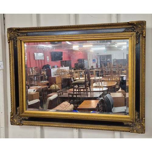 318 - A large Victorian style ebonised and parcel gilt framed mirror