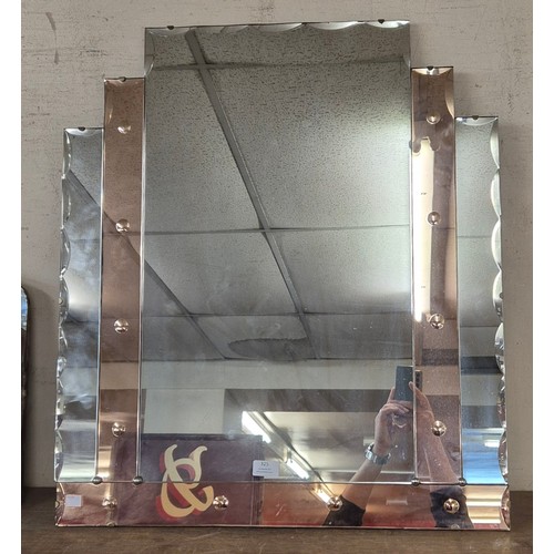 325 - An Art Deco style peach glass mirror