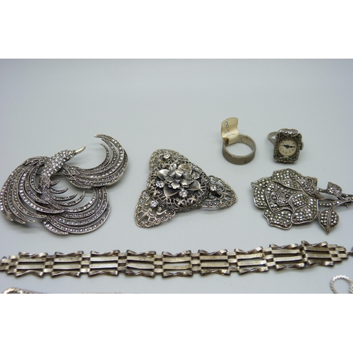 1005 - A silver and marcasite ring watch, an 800 silver ring, a silver and marcasite rose brooch, chains, e... 