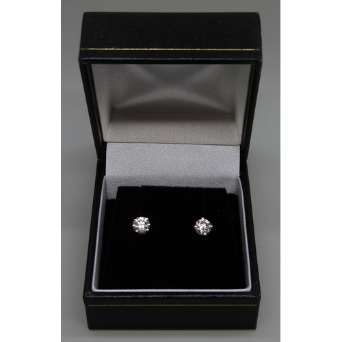 1016 - A pair of hallmarked 18ct white gold and diamond stud earrings, total diamond weight 0.88cts