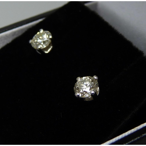 1016 - A pair of hallmarked 18ct white gold and diamond stud earrings, total diamond weight 0.88cts