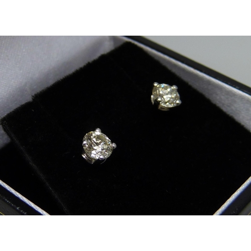 1016 - A pair of hallmarked 18ct white gold and diamond stud earrings, total diamond weight 0.88cts