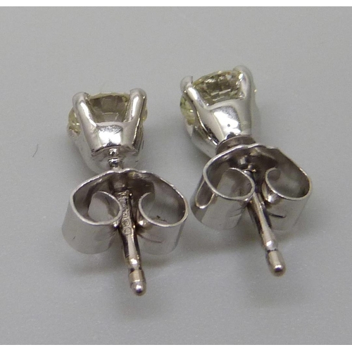 1016 - A pair of hallmarked 18ct white gold and diamond stud earrings, total diamond weight 0.88cts