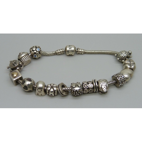 1018 - A silver Pandora bracelet with fourteen charms