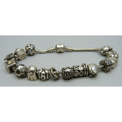 1018 - A silver Pandora bracelet with fourteen charms