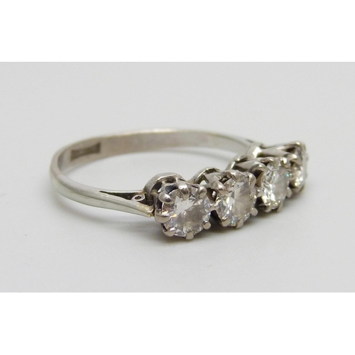 1022 - A white metal set four stone diamond ring, 2.5g, L