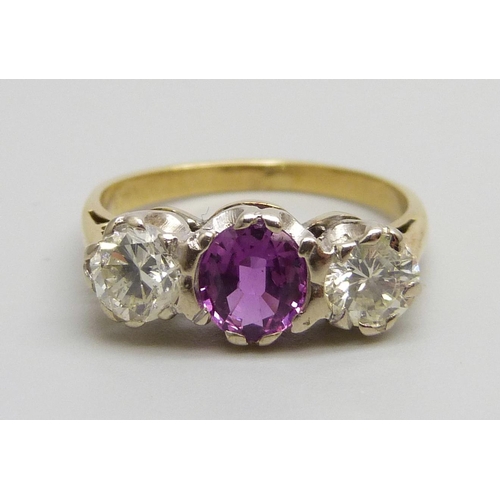 1060 - An 18ct gold, three stone diamond and pink stone ring, 3.3g, J/K, diamonds approximately 0.4ct weigh... 