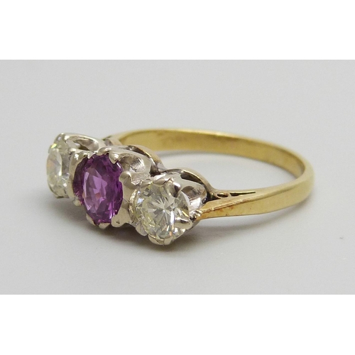 1060 - An 18ct gold, three stone diamond and pink stone ring, 3.3g, J/K, diamonds approximately 0.4ct weigh... 