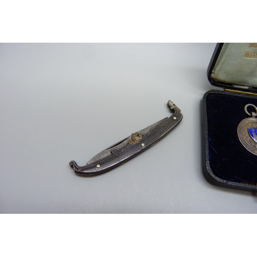 1066 - A novelty Venezia pocket knife in the form of a gondola and a silver Surrey Football fob medal, hall... 