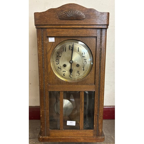 333 - An early 20th century oak wall clock