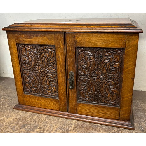 336 - A Victorian carved oak smokers cabinet