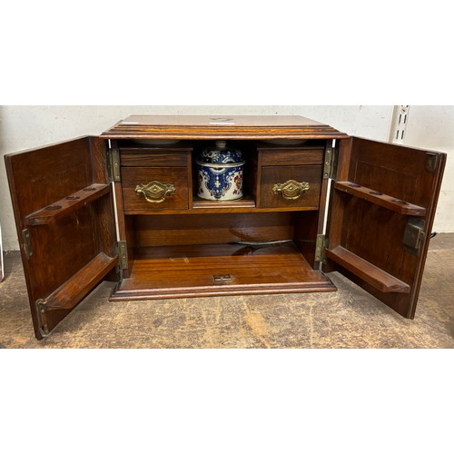 336 - A Victorian carved oak smokers cabinet