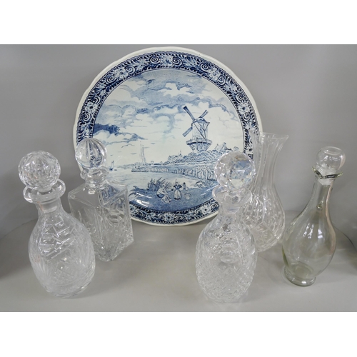 1134 - A box of five crystal decanters and carafe and a Delft blue and white charger **PLEASE NOTE THIS LOT... 