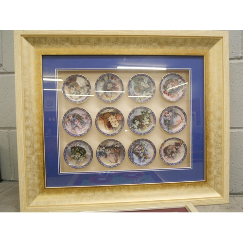 1147 - A framed set of twelve miniature plates decorated with flowers and a ceramic wall tik=le plaque, fra... 