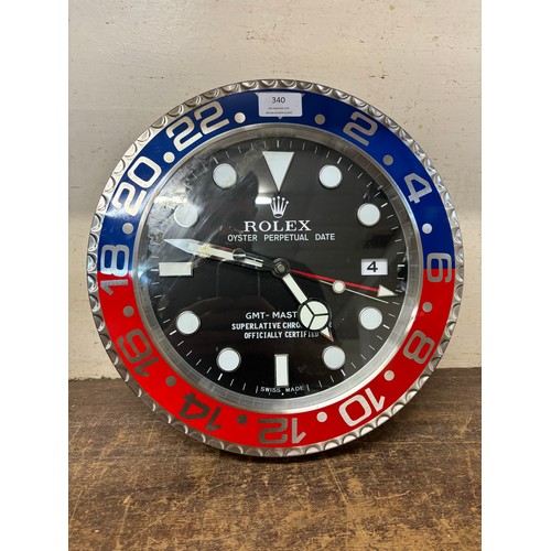 340 - A Rolex style dealers display wall clock