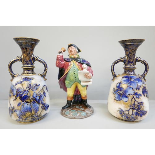 606 - A Royal Doulton figure, Town Crier and a pair of early 20th century Royal Doulton vases, both a/f