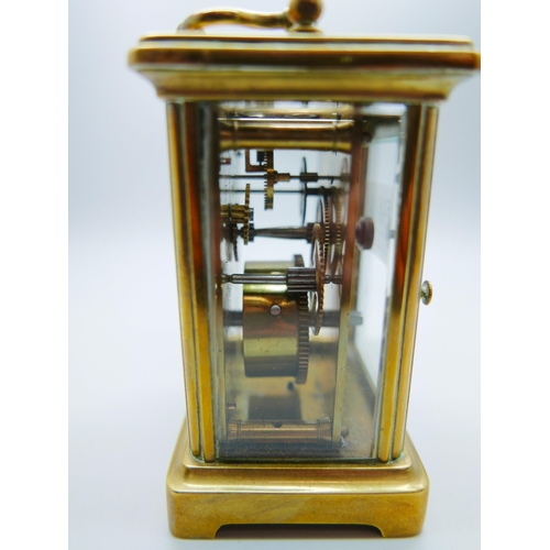 618 - A brass and four glass sided mantel timepiece, with key