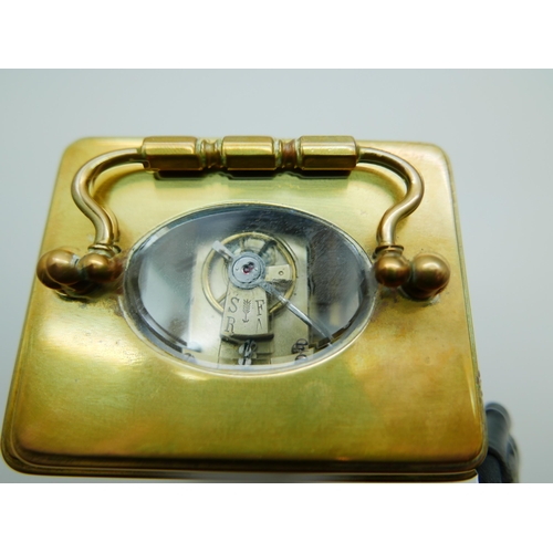 618 - A brass and four glass sided mantel timepiece, with key