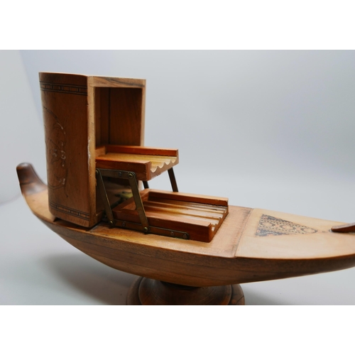 625 - A wooden cigarette dispenser, marquetry inlay, musical, in the form of a boat