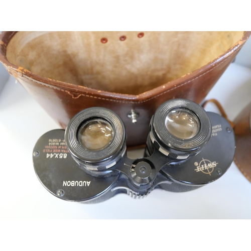 686 - A pair of Swift 8.5 x 44 extra wide field binoculars in a leather case, two belts with metal buckles... 