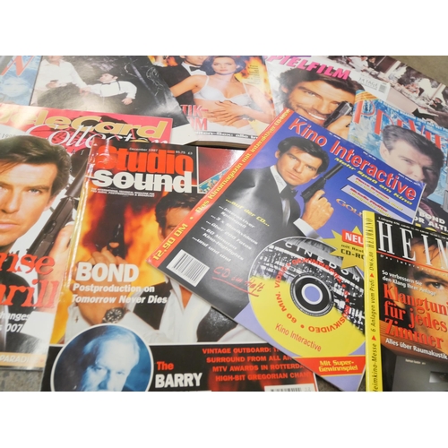 714 - James Bond; two boxes of magazines, lobby cards, etc., (2)