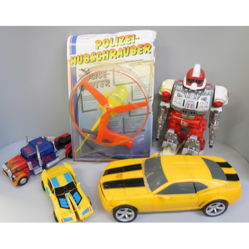 756 - A group of three Transformers toys, a battery operated robot and one other