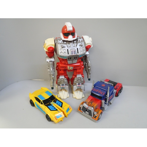 756 - A group of three Transformers toys, a battery operated robot and one other