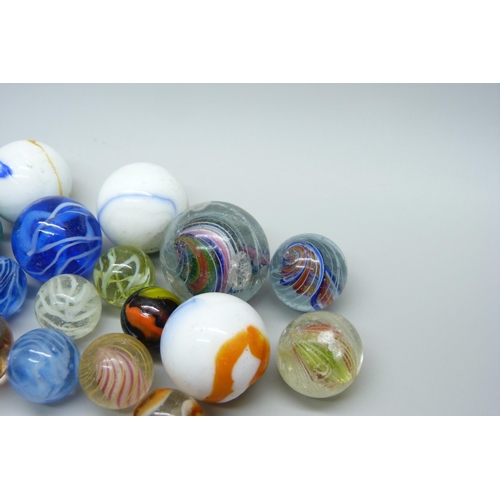 807 - A large collection of marbles including vintage caged cat's eye, wire pull, latticino, British and c... 