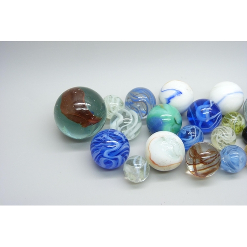 807 - A large collection of marbles including vintage caged cat's eye, wire pull, latticino, British and c... 