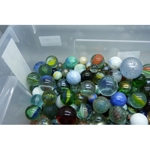 807 - A large collection of marbles including vintage caged cat's eye, wire pull, latticino, British and c... 