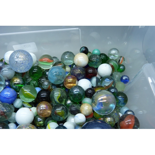 807 - A large collection of marbles including vintage caged cat's eye, wire pull, latticino, British and c... 