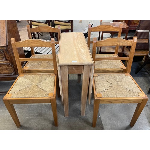 221 - An elm drop leaf table and four chairs