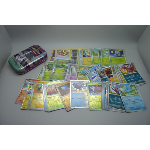 828 - 100 plus holographic Pokémon cards including reverse holo and collector's tins