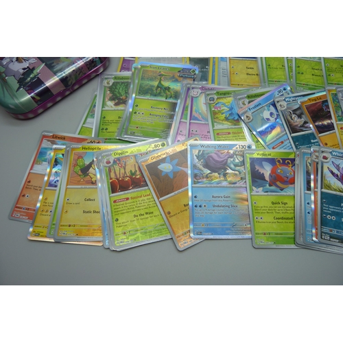 828 - 100 plus holographic Pokémon cards including reverse holo and collector's tins