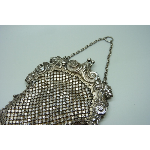 838 - A silver evening purse with lion's head detail, marked 'sterling W & D'