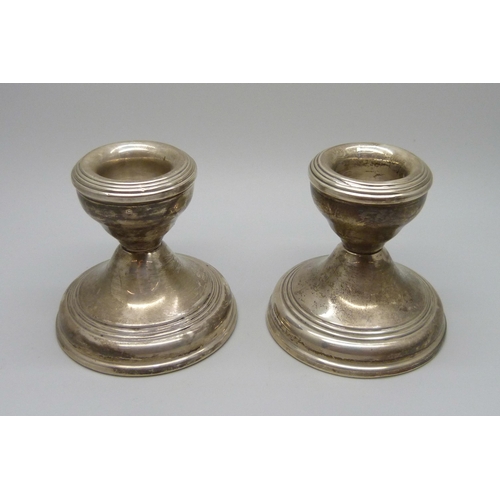 853 - A pair of small silver candlesticks